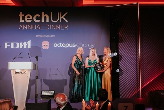 Dr Laura Bishop, AI and cyber security digital sector lead at BSI, accepts the Society Award from TechUK president Sheila Flavell and deputy president Nicola Hodson