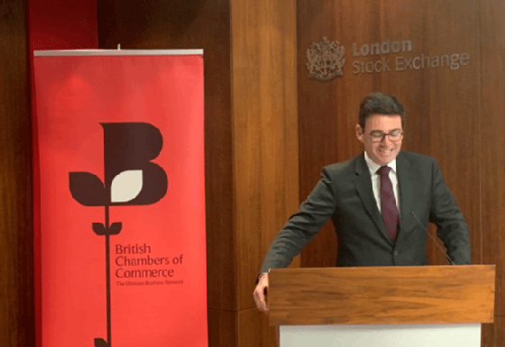 Andy Burnham at a lectern at the London Stock Exchange during a British Chambers of Commerce event in 2019